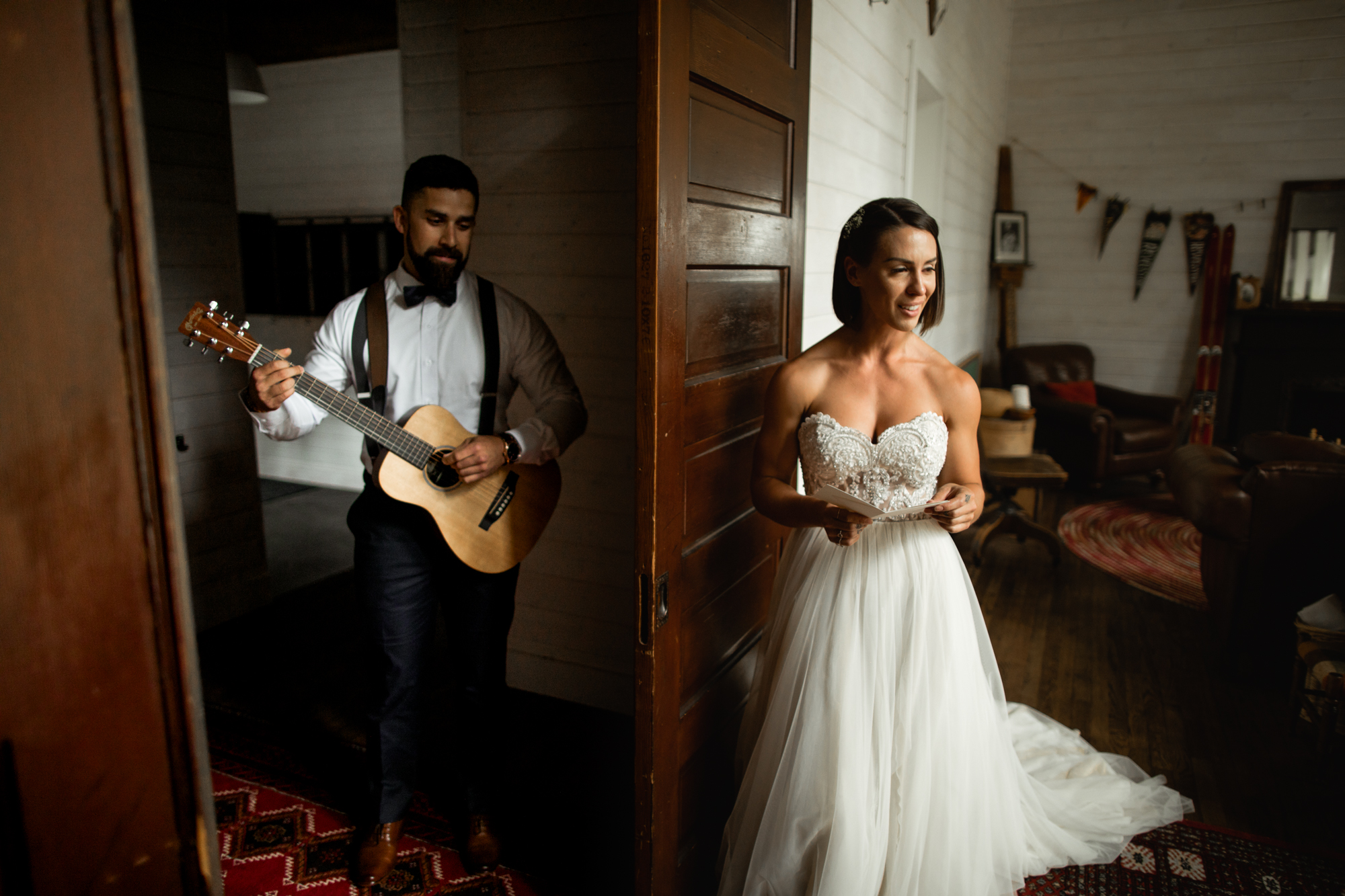 groom playing guitar to bride