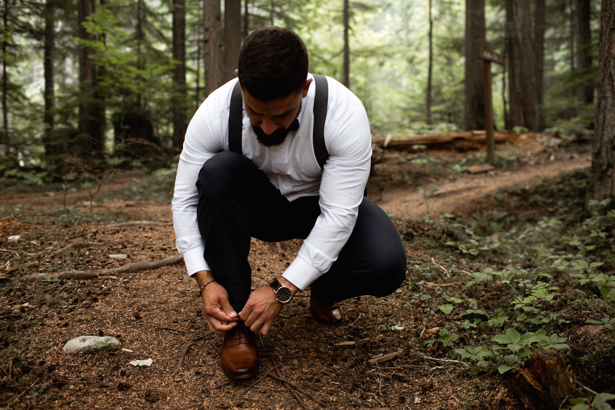 groom tying up shoe