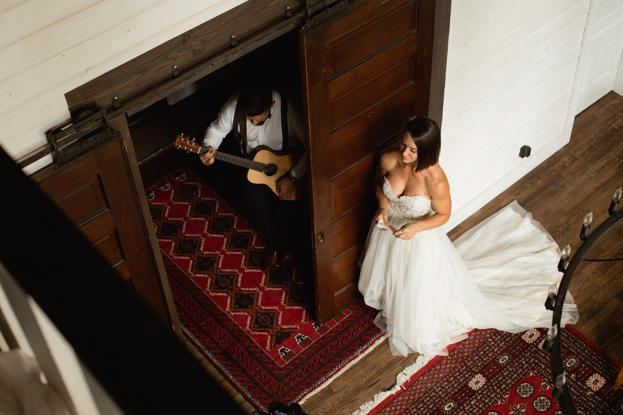 groom playing guitar to bride