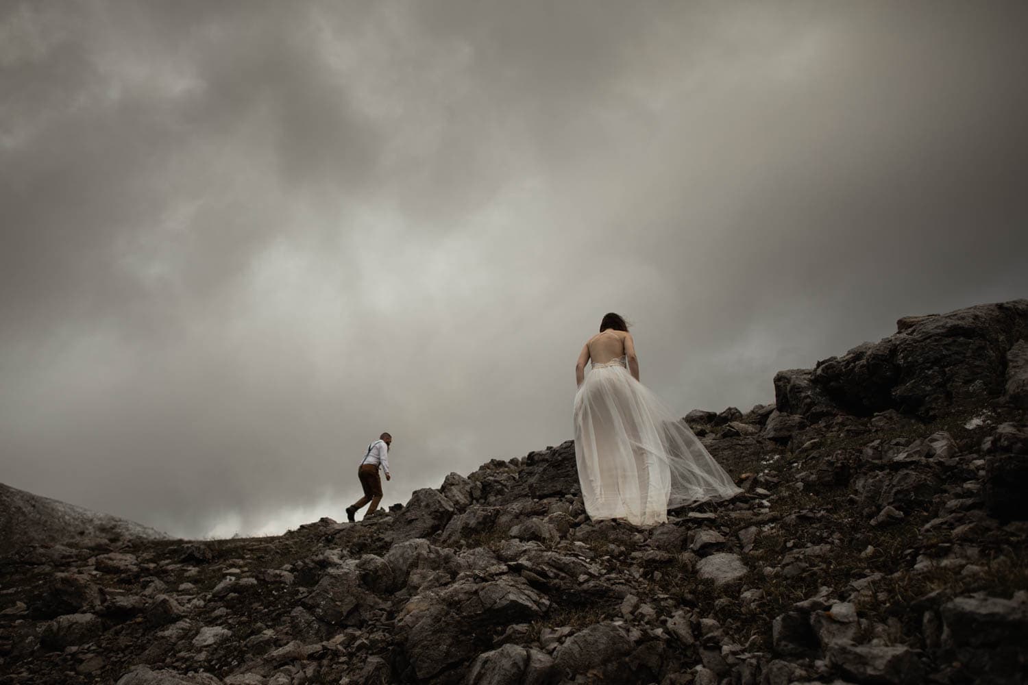 Bride and Groom Climbing Mountain