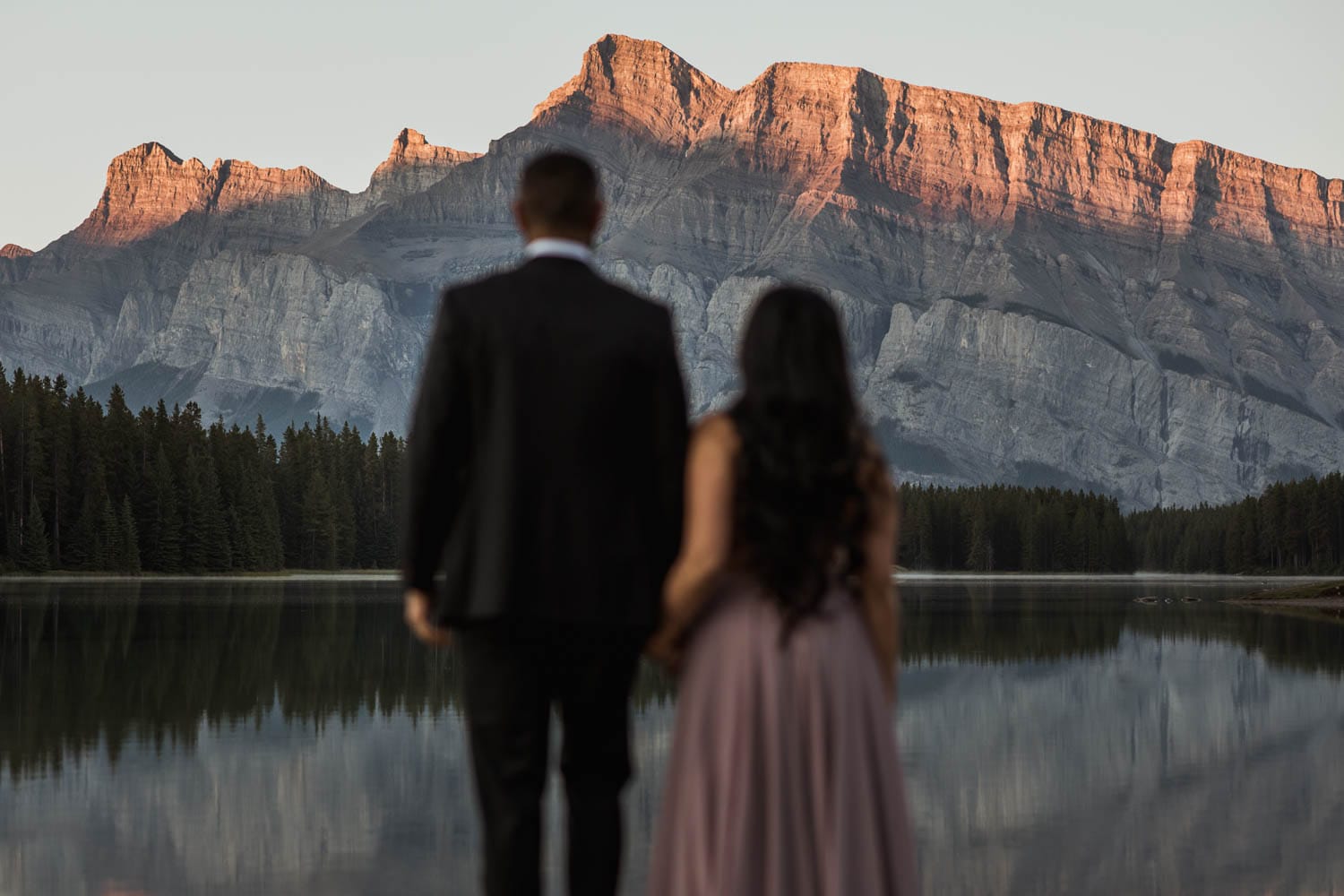 Engaged Couple looking at mountains in Banff