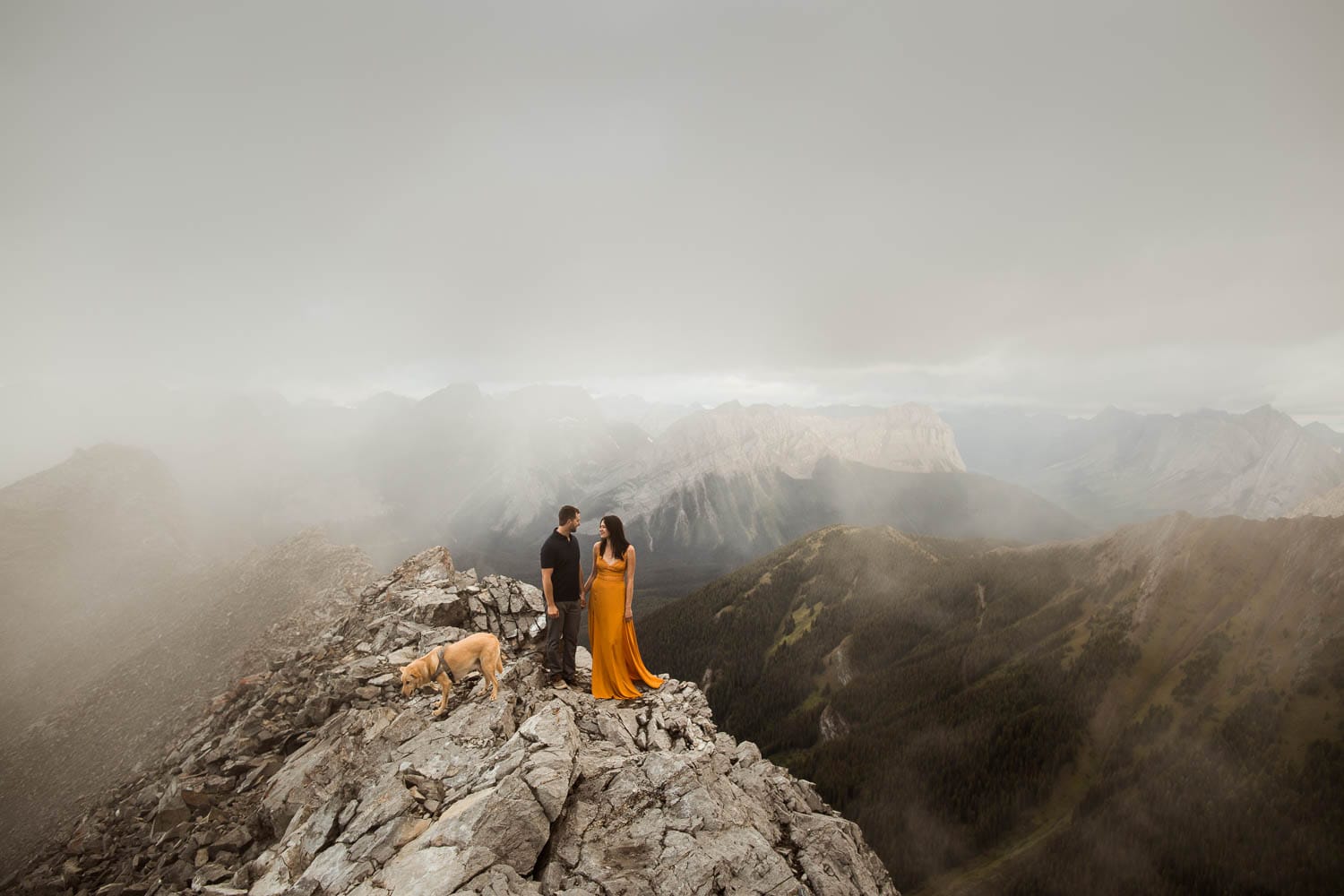 Couple and dog on mountain top