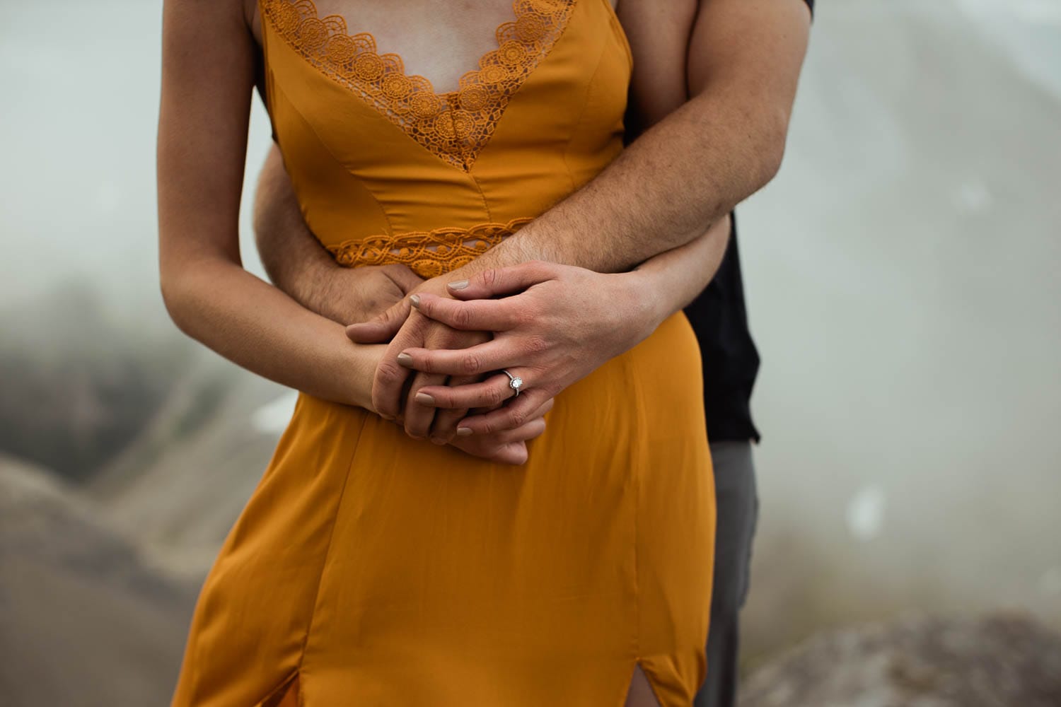 engaged couple holding each other