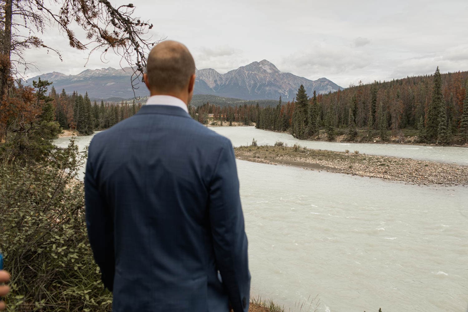 Groom looking out at lake