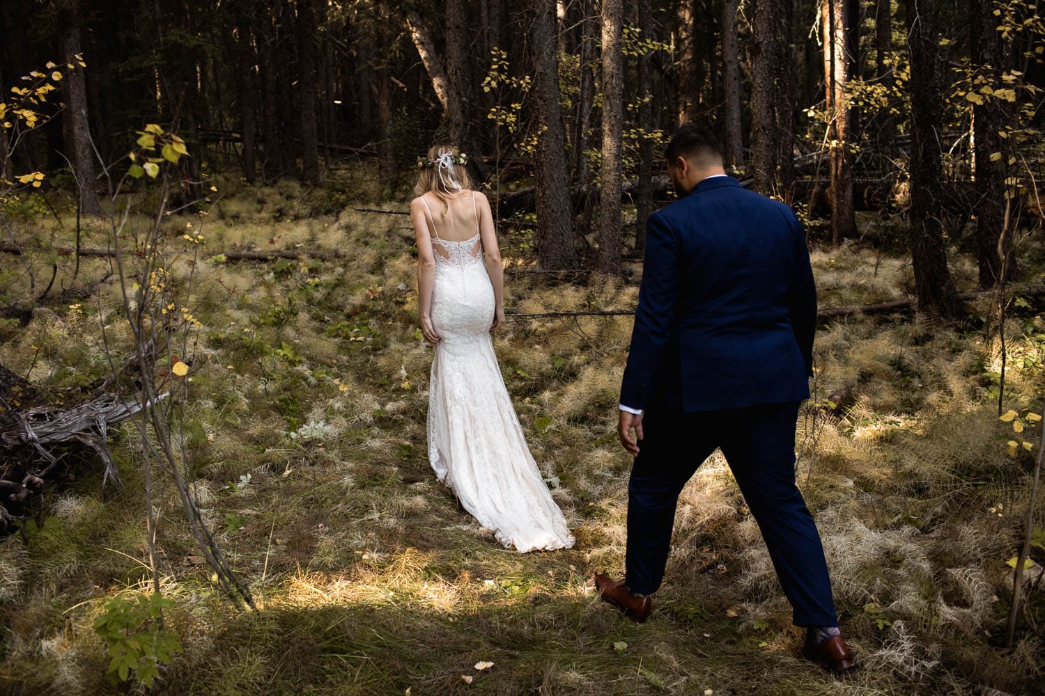 bride and groom walking in forest