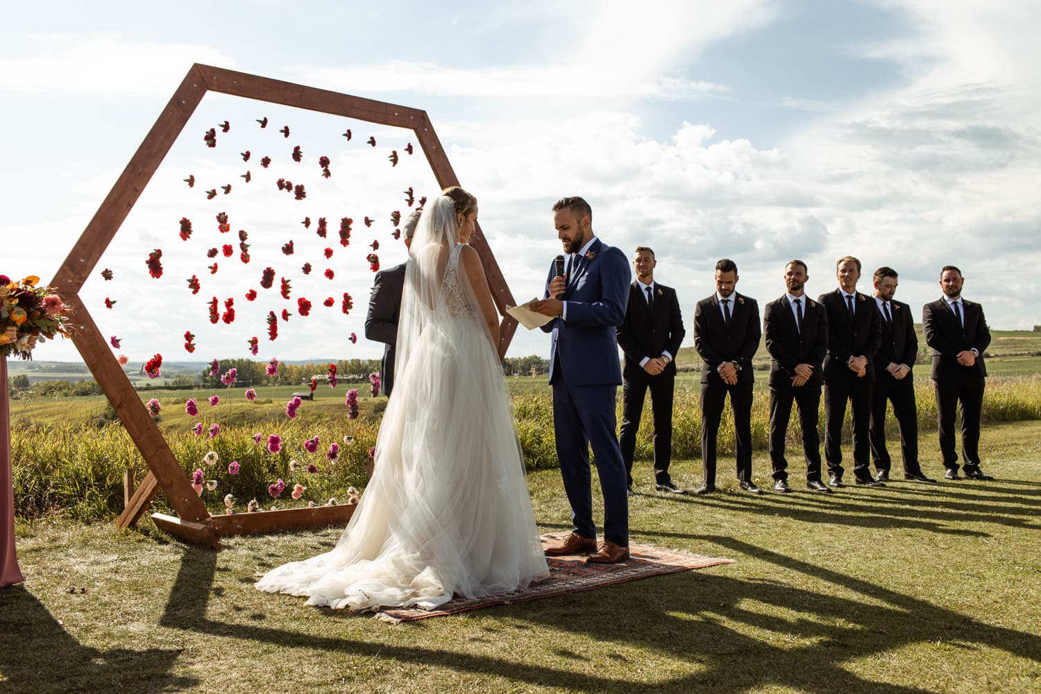 groom reading vows at wedding ceremony