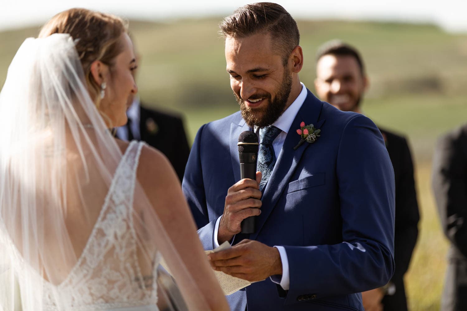 groom reading vows at wedding ceremony