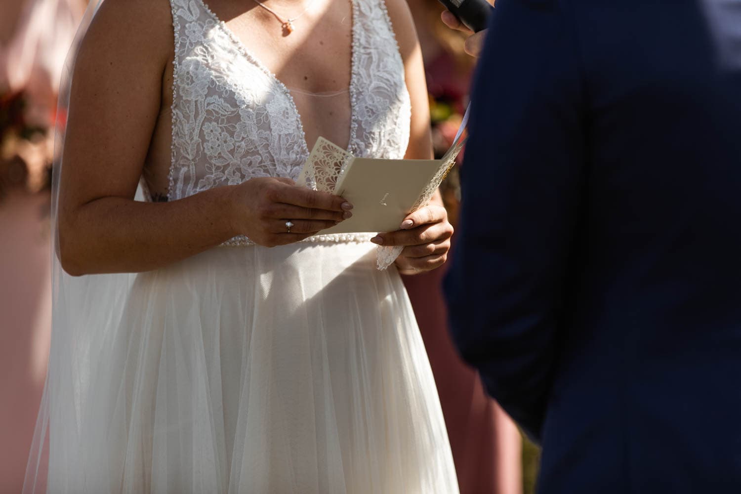 bride reading vows at wedding ceremony