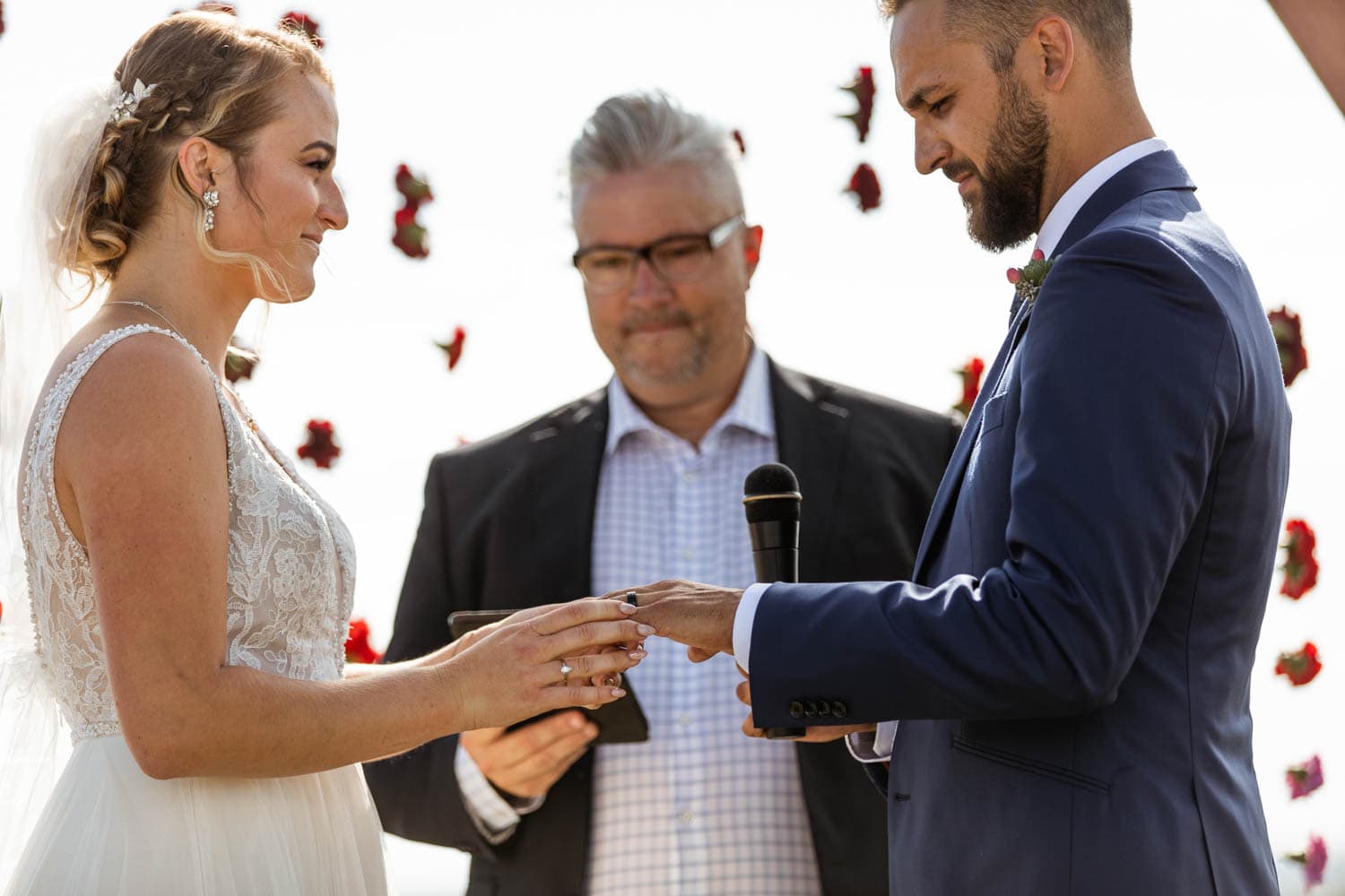 bride and groom exchanging rings at wedding ceremony
