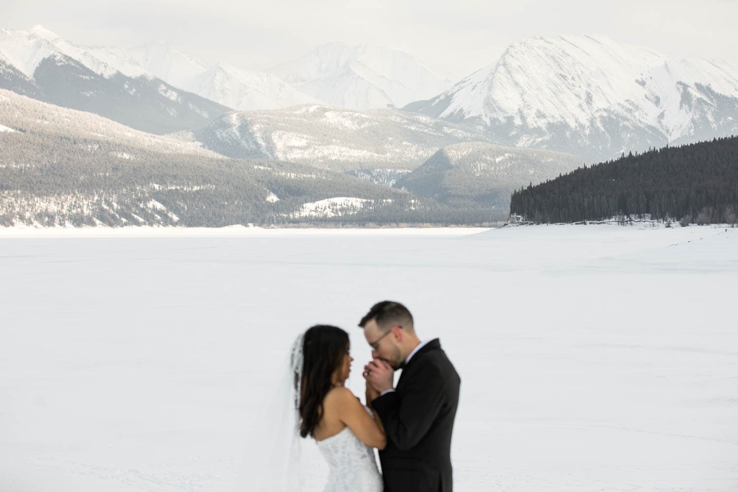 bride and groom in winter mountains