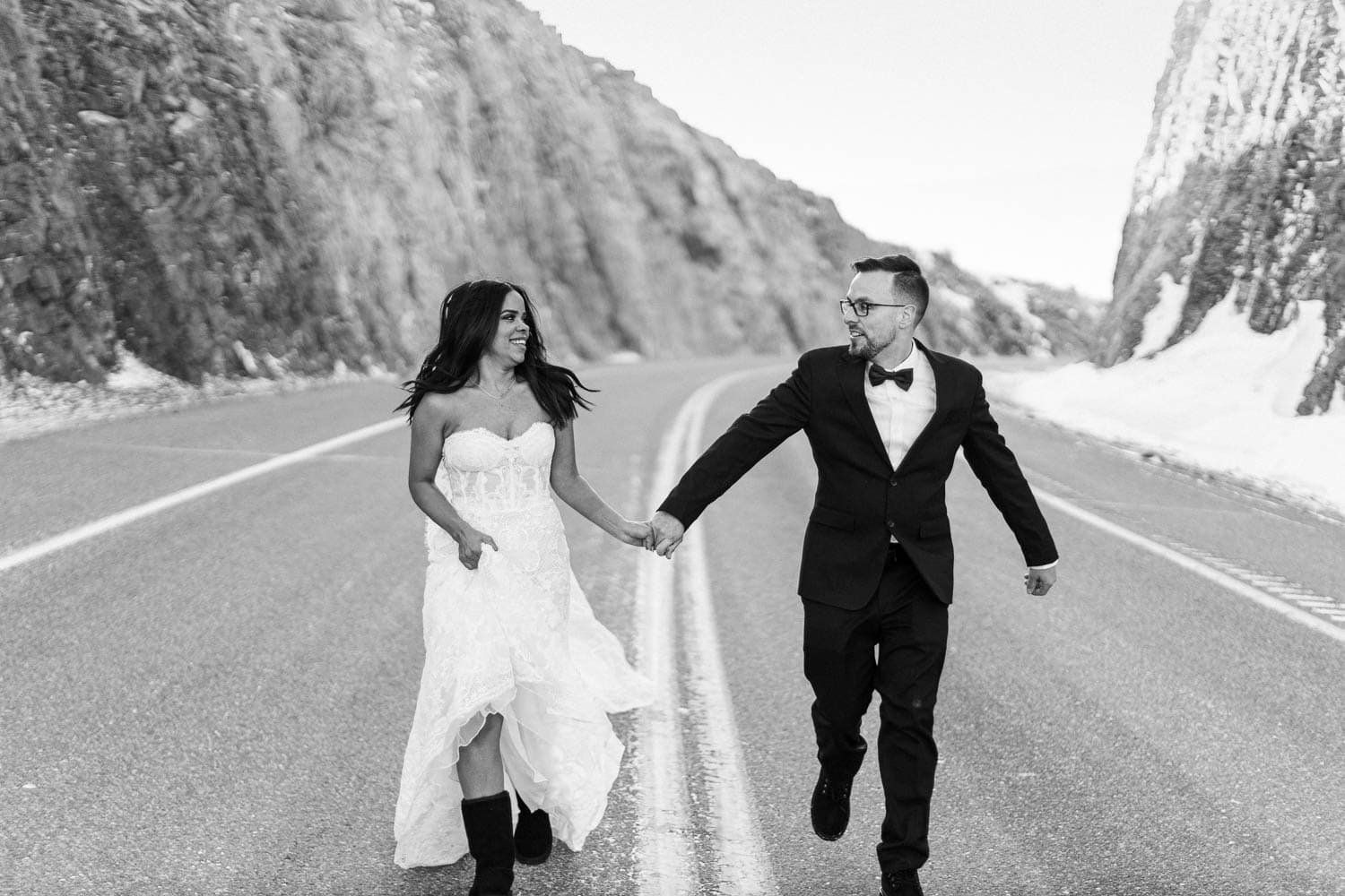 bride and groom running down road