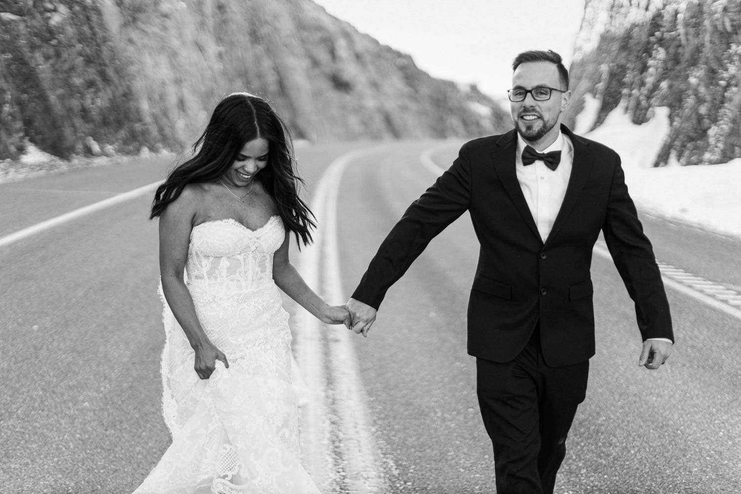 bride and groom running down road