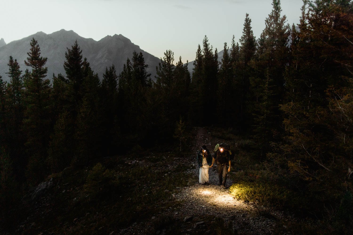 bride and groom hiking by headlamp